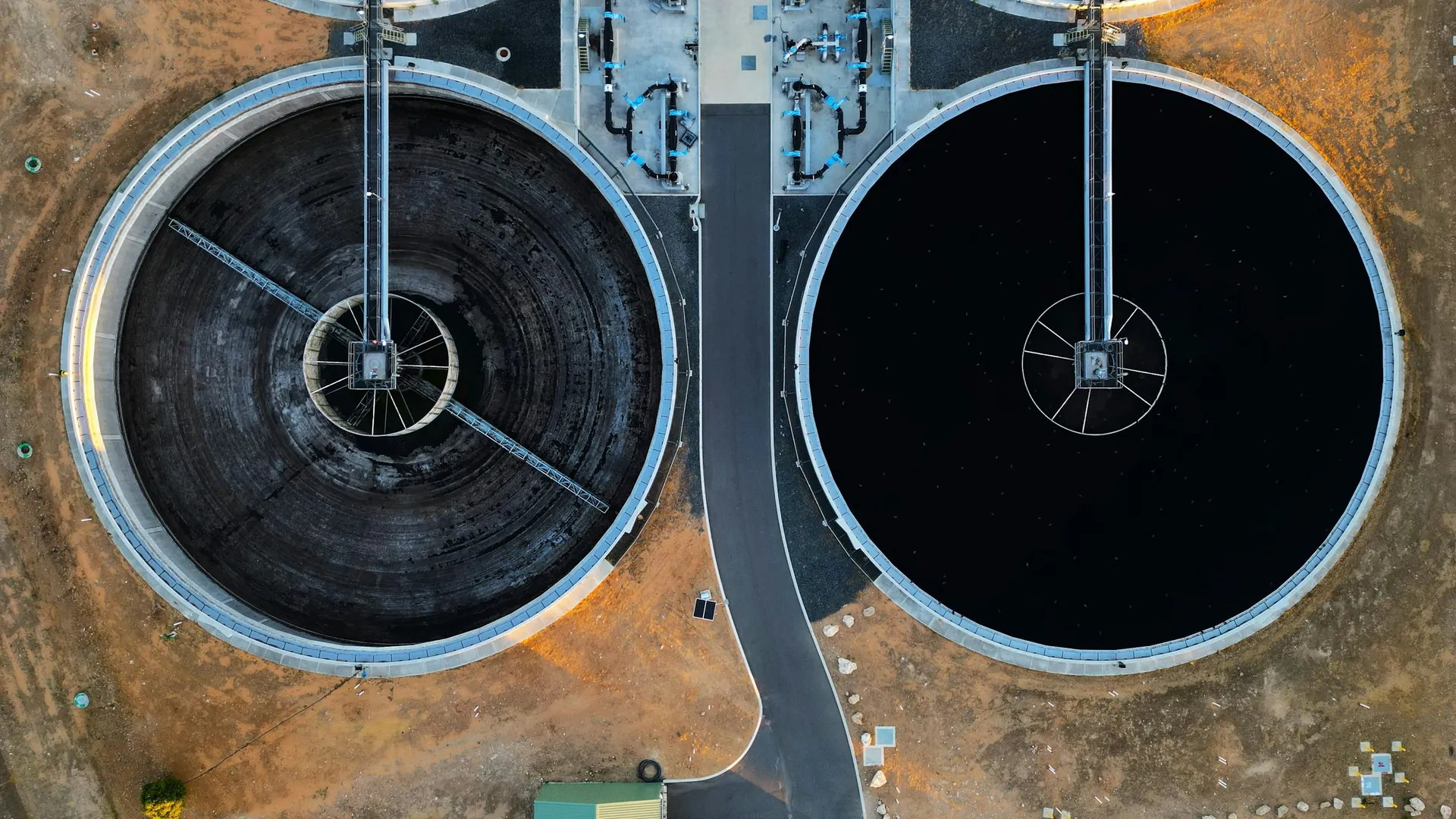 Two circular clarifiers seen from above, with bridges and launders