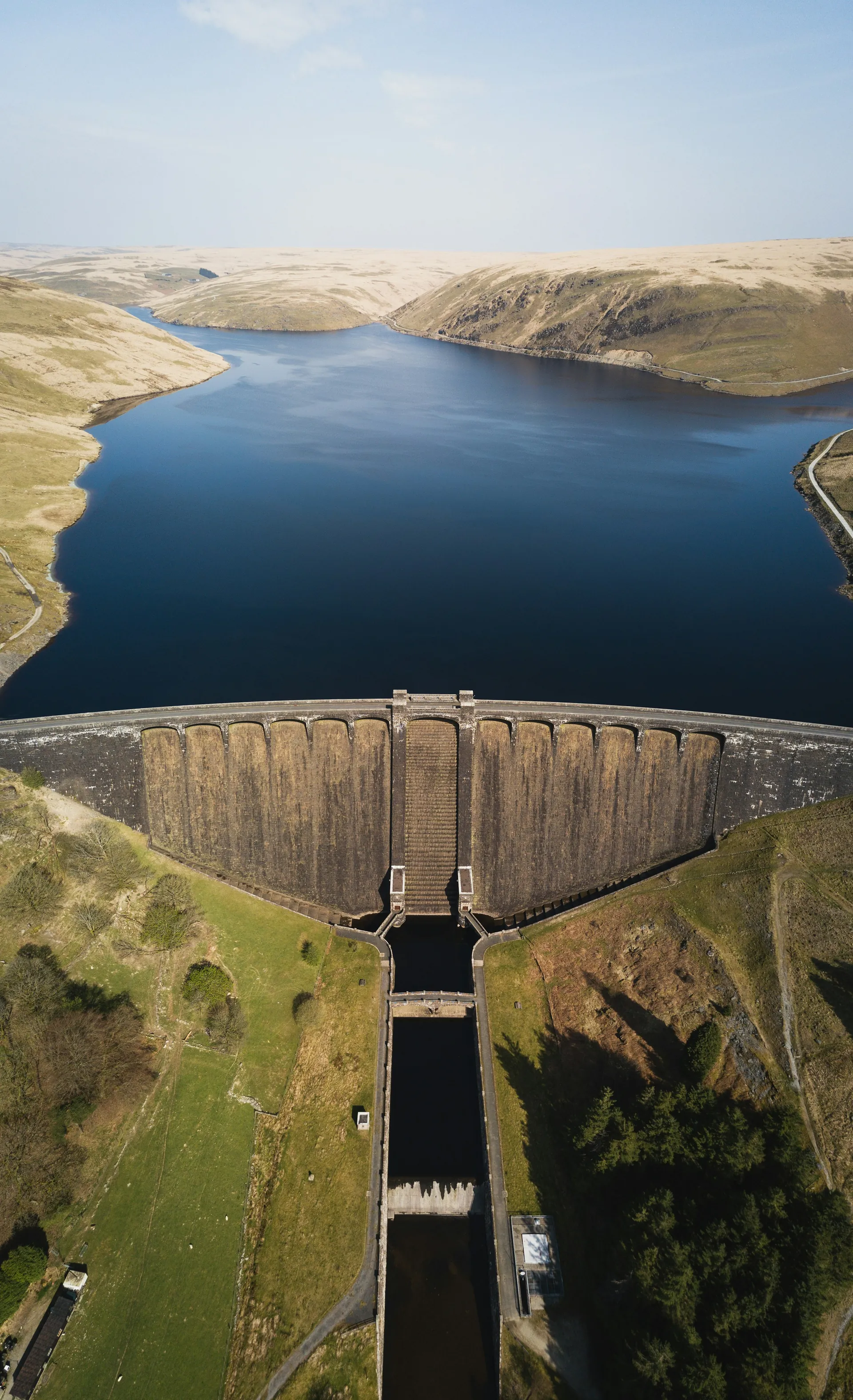 Aerial view of a concrete dam and its reservoir