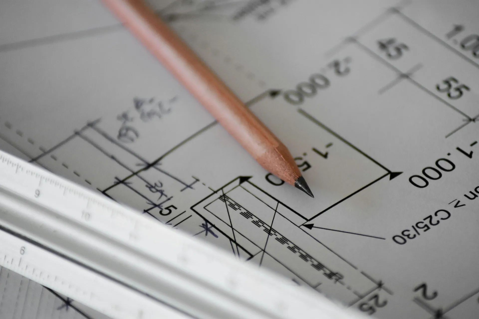 Pencil resting on a technical engineering drawing