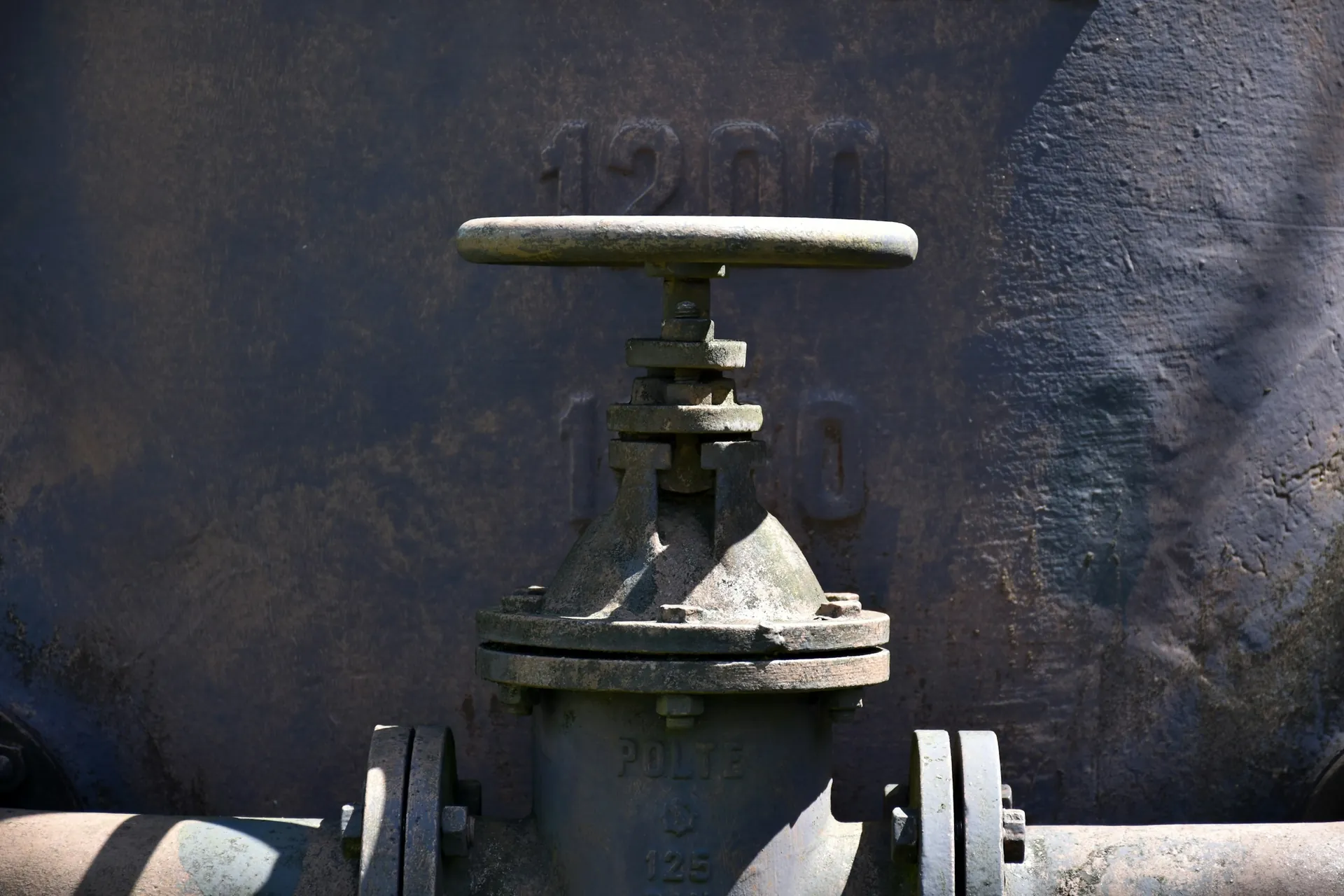 Close-up of a cast-iron gate valve and handwheel