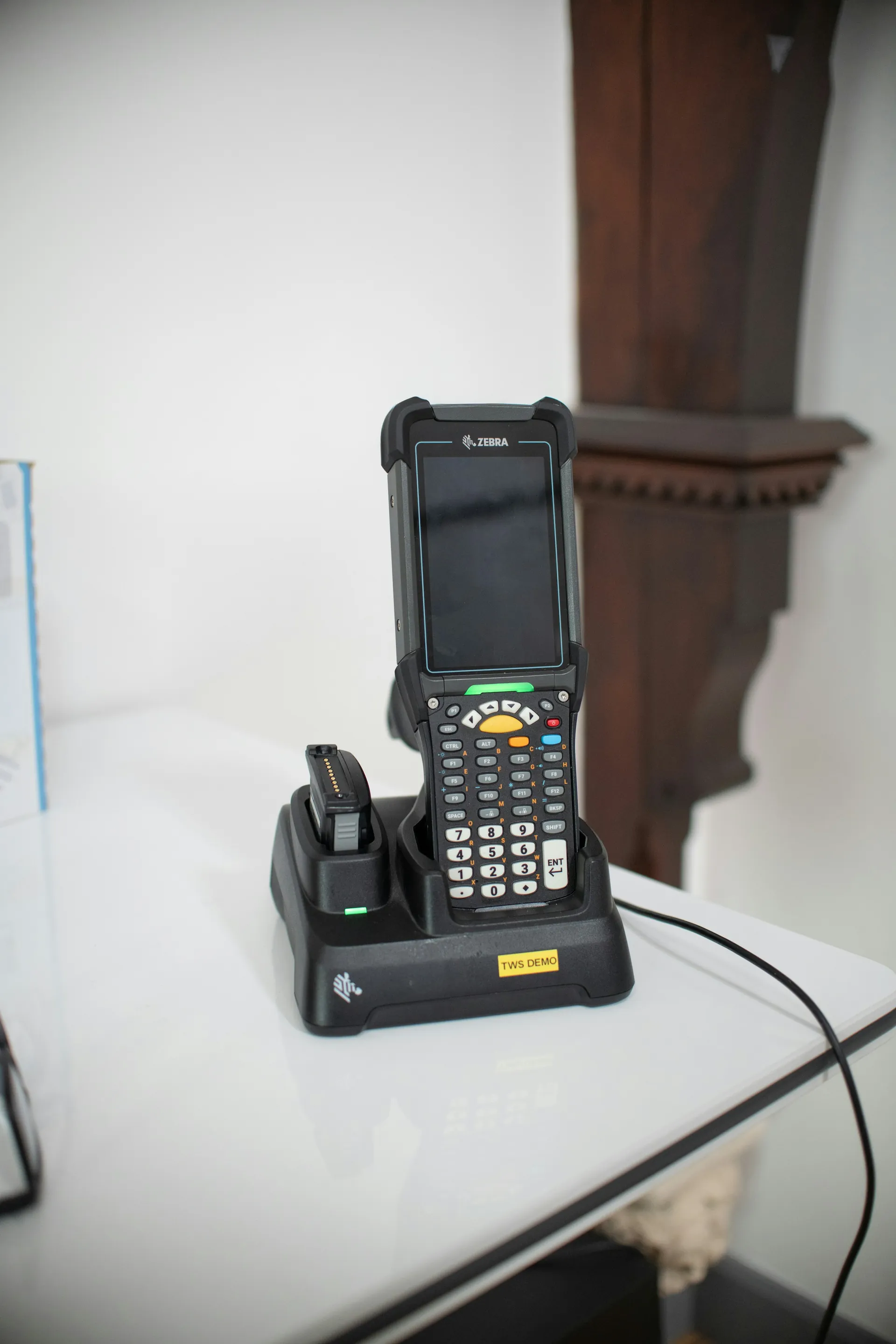 Rugged handheld scanner resting in its charging dock