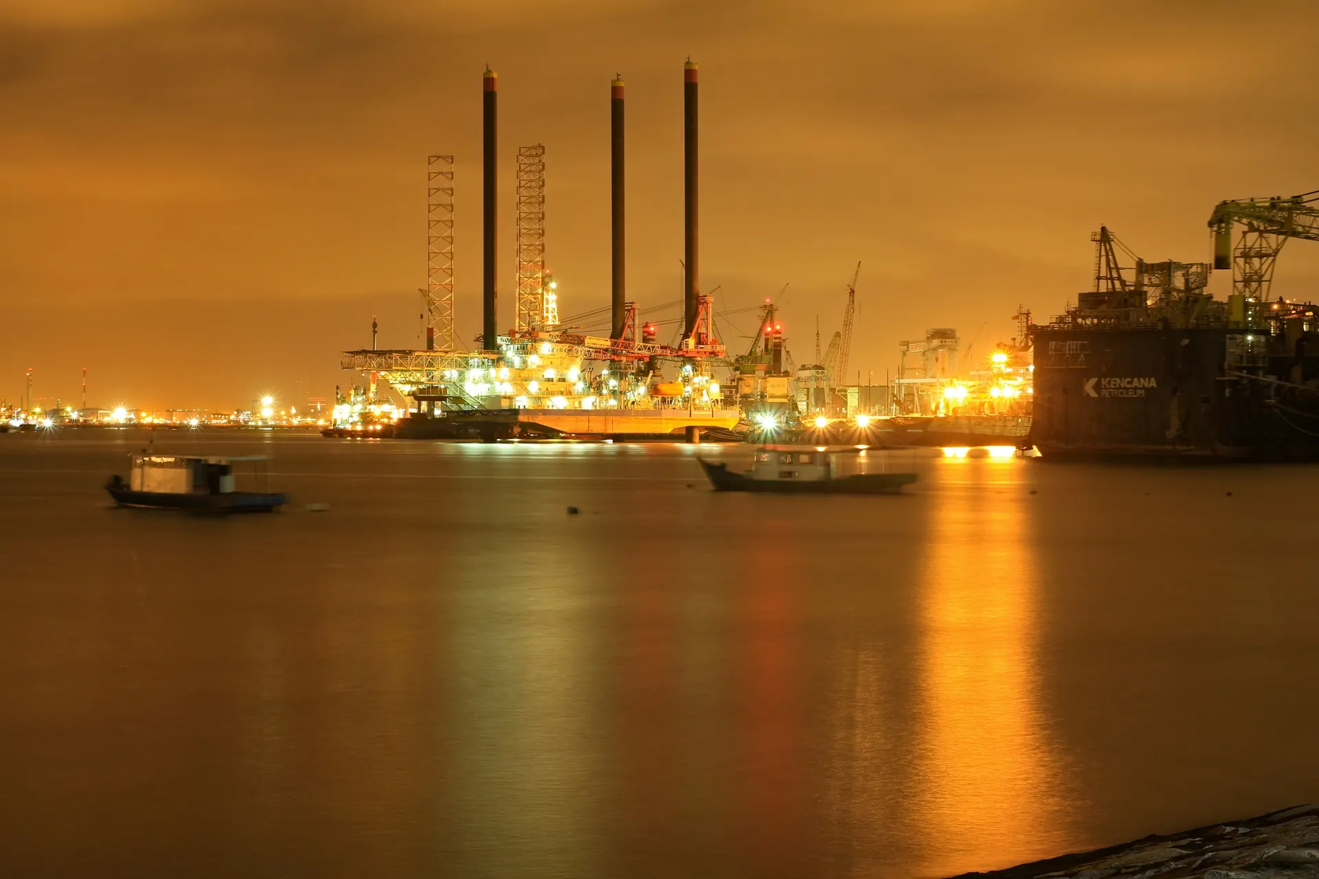 Industrial waterfront and offshore structures at dusk