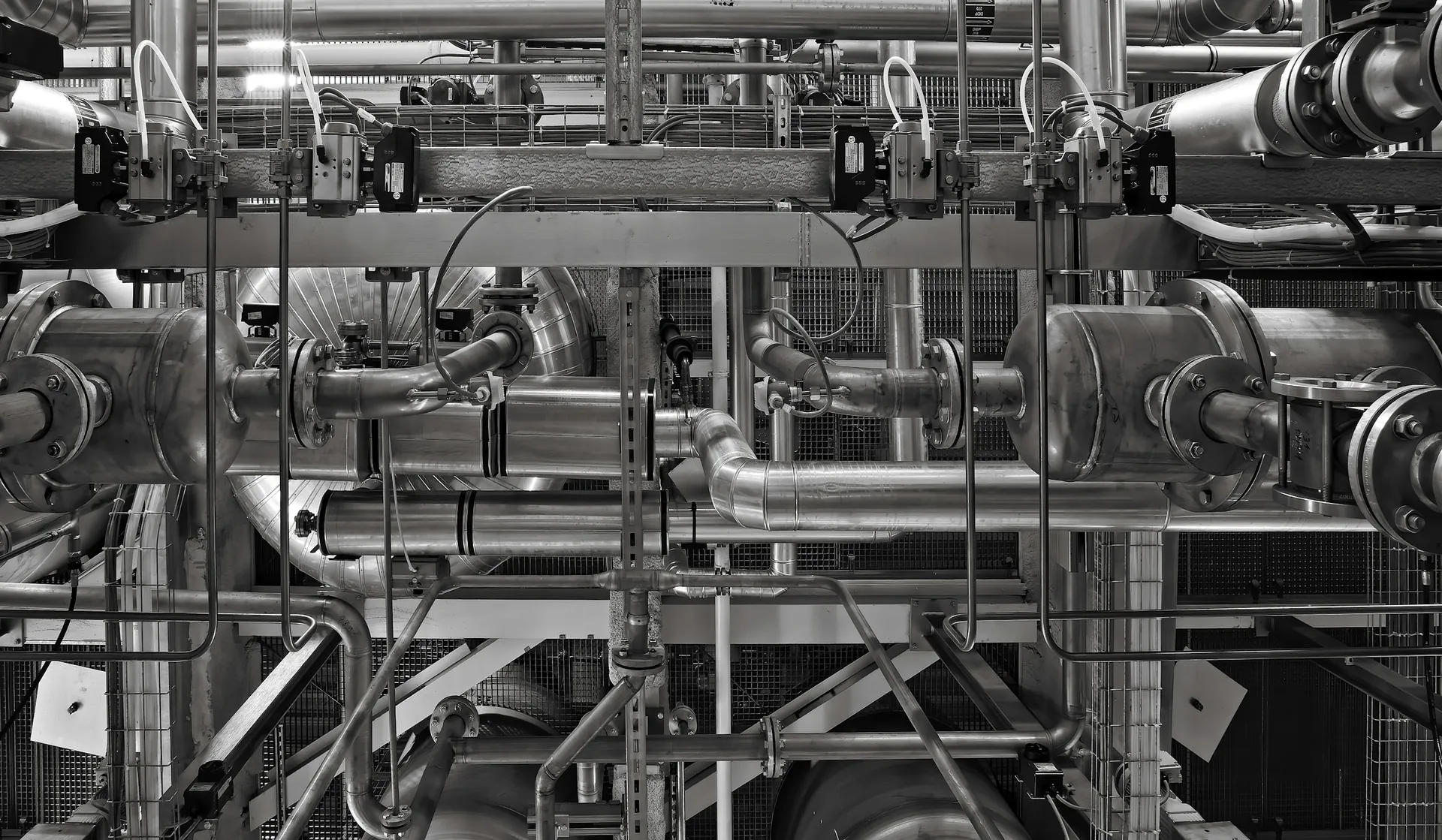 Dense network of stainless-steel process pipes and valves