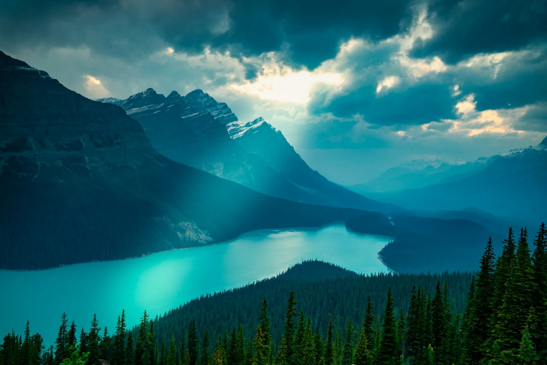 Turquoise lake in the Canadian Rockies beneath dramatic clouds