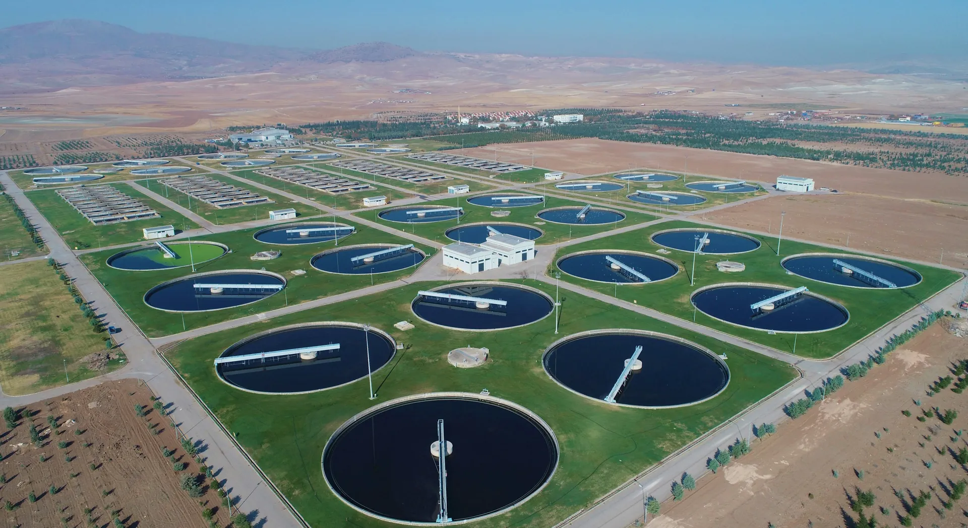 Treatment plant with rows of circular basins in an arid landscape