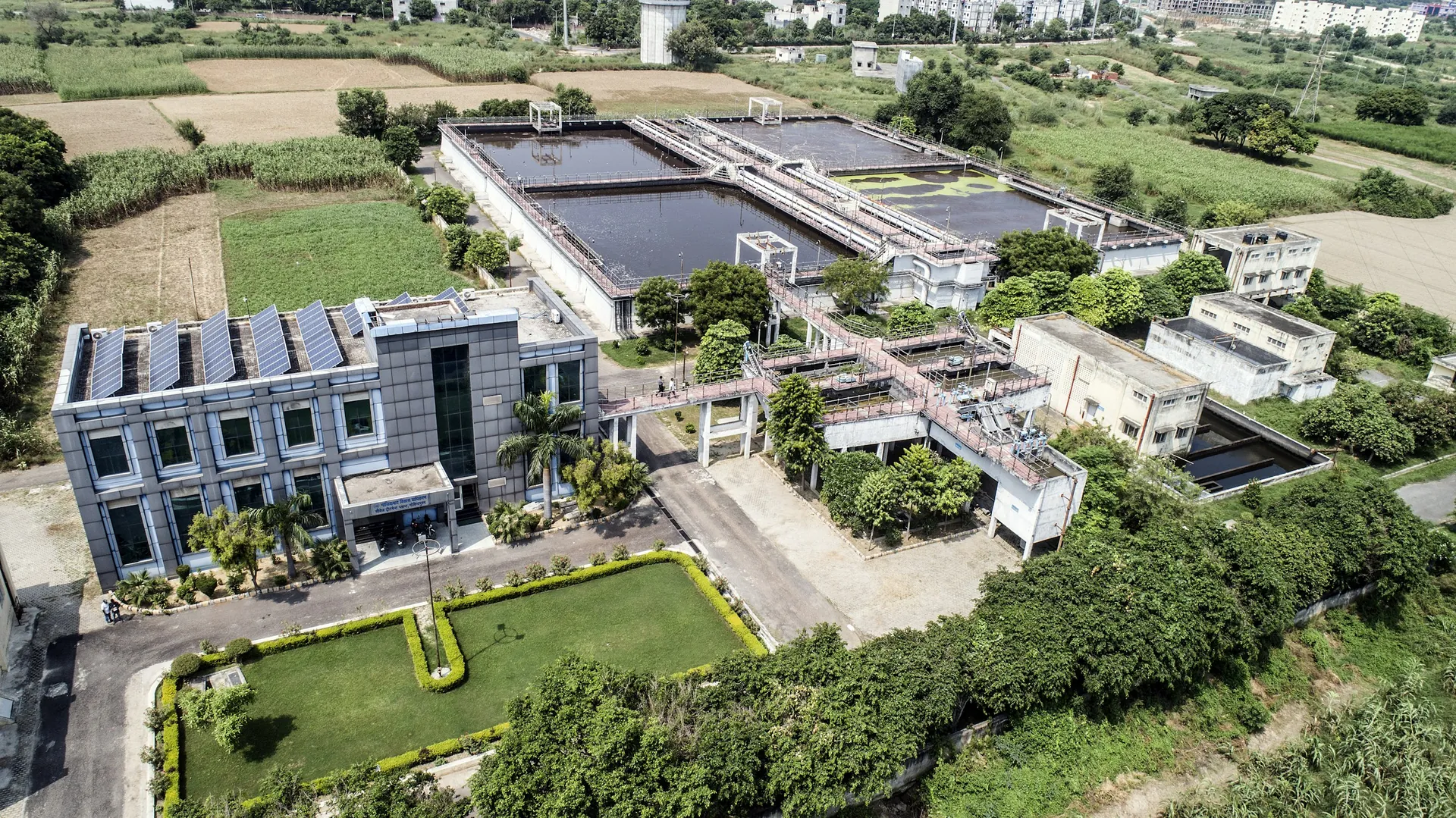 Aerial view of a water treatment plant surrounded by fields