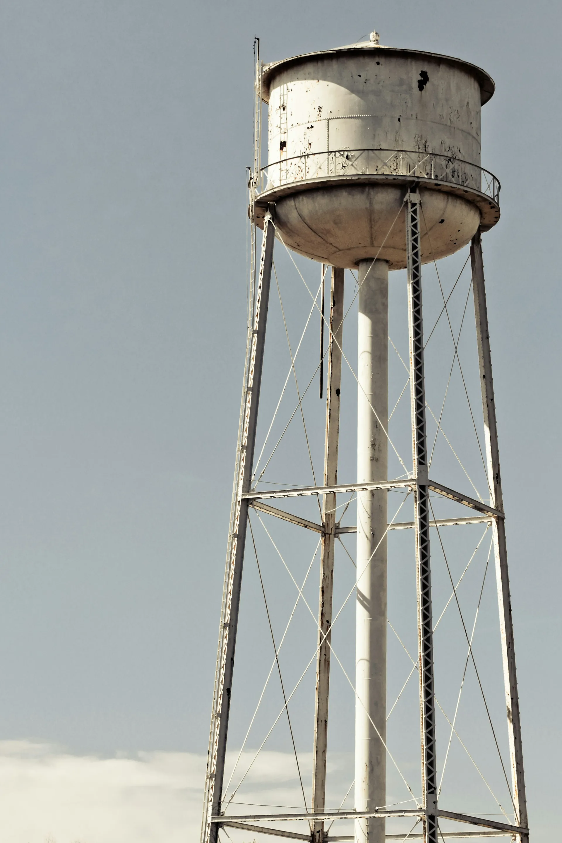 Steel water tower against a pale sky