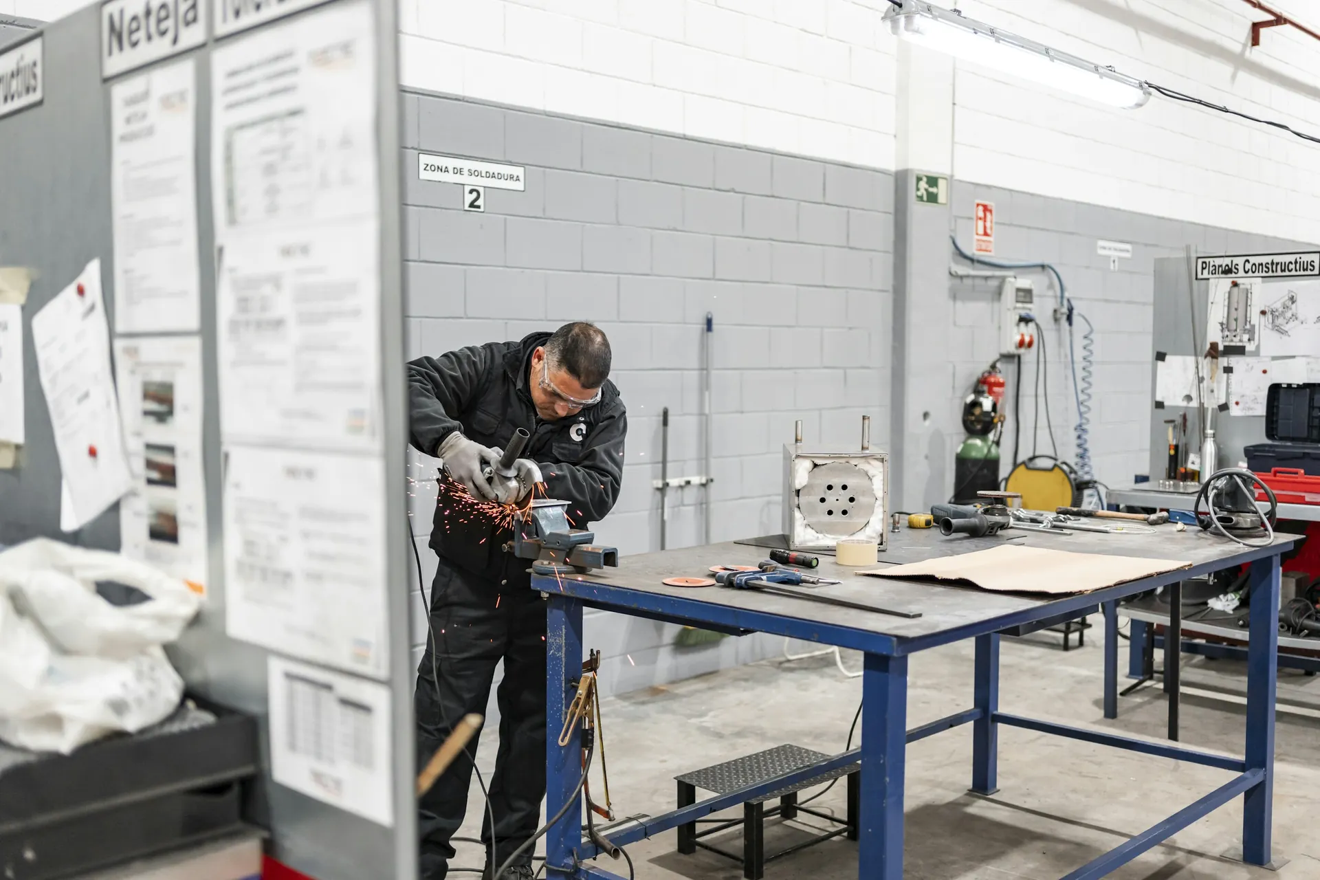 Technician working at a bench in a fabrication workshop